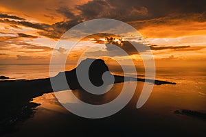 Aerial view with ocean at warm sunset time and Le Morn mountain in Mauritius