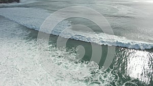 Aerial View Of Ocean Waves Crashing On Shore In Indonesia.