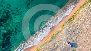 Aerial view of ocean waves and sand on beach