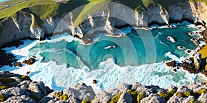 Aerial view of ocean waves at sunset. Beautiful nature background. Aerial view of sea waves crashing on the beach. Top view.