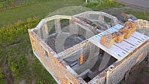 Aerial view od new brick unfinished house under construction.