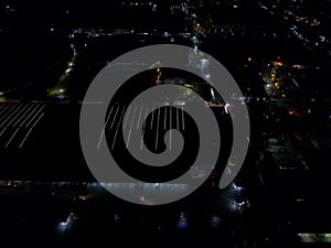 aerial view of office building and warehouse distribution center of retail based company at night