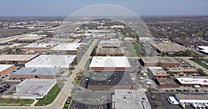 Aerial view of an office park with low-rise buildings near a highway in a suburban setting