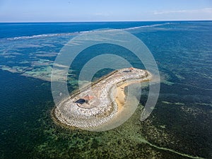 Aerial view of an offshore gazebo sheltered by a large, fringing tropical coral reef