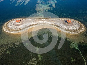 Aerial view of an offshore gazebo sheltered by a large, fringing tropical coral reef