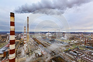 Aerial view of oil and gas industry - refinery in cloudy day - factory - petrochemical plant and a lot of chimneys with smoke and