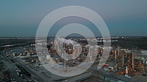 Aerial view of Oil and gas petrol fuel chemical tank with oil refinery petrochemical plant at twilight,