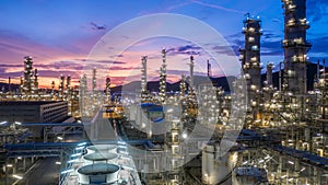 Aerial view oil and gas tank with oil refinery background at night, Glitter lighting of petrochemical plant with night,