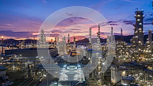 Aerial view oil and gas tank with oil refinery background at night, Glitter lighting of petrochemical plant with night,