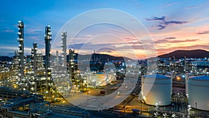 Aerial view oil and gas tank with oil refinery background at night, Glitter lighting of petrochemical plant with night,