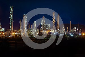 Aerial view oil refinery night with mountain background during t