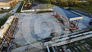 Aerial view of oil storage depot with set of tanks with fuel transported by rail. Stock. Aerial view of petrol