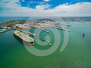 Aerial view of oil tanker moored at industrial port. Williamstown, Victoria, Australia.