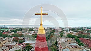 Aerial view of the old city and Christian cross on top of the spire of Odessa Lutheran St. Paul`s Cathedral