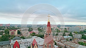 Aerial view of the old city and Christian cross on top of the spire of Odessa Lutheran St. Paul`s Cathedral