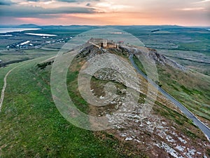 Aerial view of the old Enisala stronghold citadel standing on the hill in the sunset