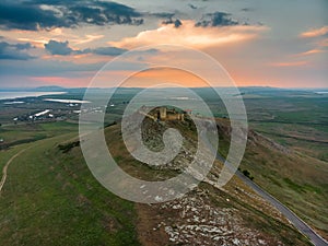 Aerial view of the old Enisala stronghold citadel standing on the hill in the sunset