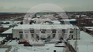 Aerial view of an old factory building facade at the industrial zone of the city. Video. The exterior of a plant on a