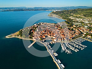 Aerial view of old fishing town Izola in Slovenia, cityscape with marina at sunset. Adriatic sea coast, peninsula of Istria