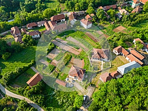 Aerial view of old houses and meadows in village in east Serbia