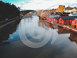 Aerial view of the old red house and barns by the river. Photo taken from a drone. Finland, Porvoo. photo