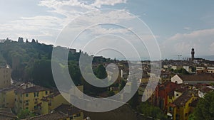 Aerial view of old residential buildings in town. Fly over high stone town walls at Porta San Miniate gate. Florence