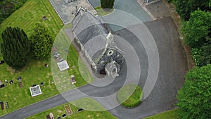 Aerial view of an old rural stone church and graveyard in Ireland