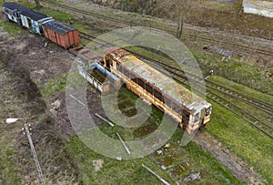 Aerial view on old, rusted and abandoned passenger wagon standing on sidetrack