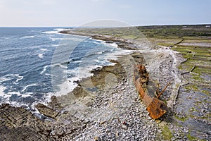 Aerial view on an old rusty abandoned ship on a rough stone coast of Inisheer, Aran island, county Galway, Ireland. Popular travel