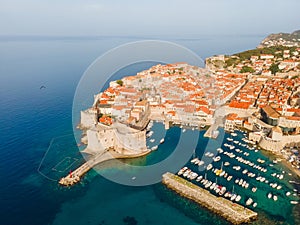 Aerial view of old town of Dubrovnik with boats and yachts in port on Adriatic sea, Dalmatia, Croatia. Medieval city