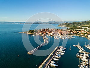 Aerial view of old town Izola in Slovenia, cityscape with marina at sunset. Adriatic sea coast, peninsula of Istria, Europe