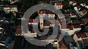 Aerial view of old town square in Croatia, Vis Island during sunset and port full of sailboats