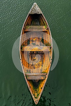 Aerial View of an Old Wooden Boat on Calm Green Water Rustic, Vintage and Timeless Beauty of Traditional Rowboat with Weathered photo