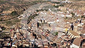 Aerial view of olt town of Fraga on bank of Cinca river in province of Huesca overlooking brownish tiled roofs of