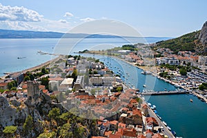 Aerial view of Omis city in Croatia and Cetina river, on blue sky Summer day. Tourism