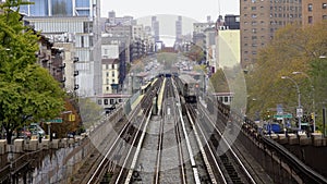 Aerial view of One Train approaching Subway Station. People using MTA Subway