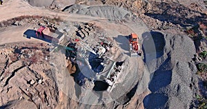 Aerial view of open cast mining panorama quarry with lots of machinery at work equipment at a plant