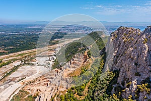 Aerial view of opencast mining quarry with lots of machinery at work view above. Area has been mined for copper, silver