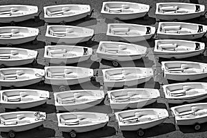 Aerial view of Optimist dinghies aligned Sailing school boats in black and white photo