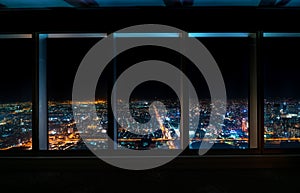 Aerial view of the Osaka skyline through a skyscraper window