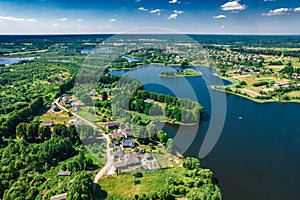 Aerial view of Ostrovno lakes, green fields and trees, small villages, summer on a sunny day, Belarus, Europe