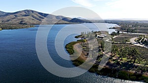 Aerial view of Otay Lake Reservoir with blue sky and mountain