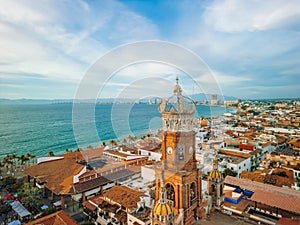 Aerial view of our Lady of Guadalupe church in Puerto Vallarta, Mexico and ocean at golden hour