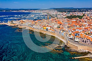 Aerial view over Alghero old town, cityscape Alghero view on a beautiful day with harbor and open sea in view. Alghero, Italy.