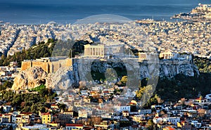 Aerial view over Athens with te Acropolis and harbour from Lycabettus hill, Greece at sunrise