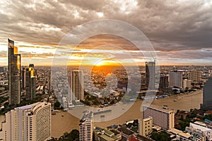 Aerial view over Bangkok modern office building in bangkok business zone near the river with sunset sky in Bangkok,