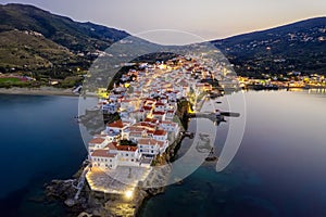 Aerial view over the beautiful illuminated town of Andros island, Greece,