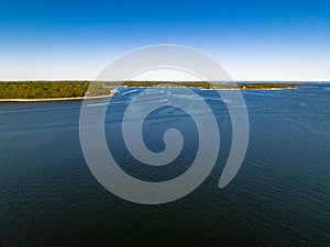 Aerial view over the calm waters in Oyster Bay near Lloyd Harbor, New York on a sunny day