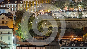 Aerial view over the center of Lisbon to the viewpoint called Miradouro de Sao Pedro de Alcantara night timelapse.