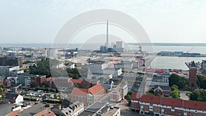 Aerial view over the city of Esbjerg with his harbor and the chimney of the coal and oil fueled power plant. This